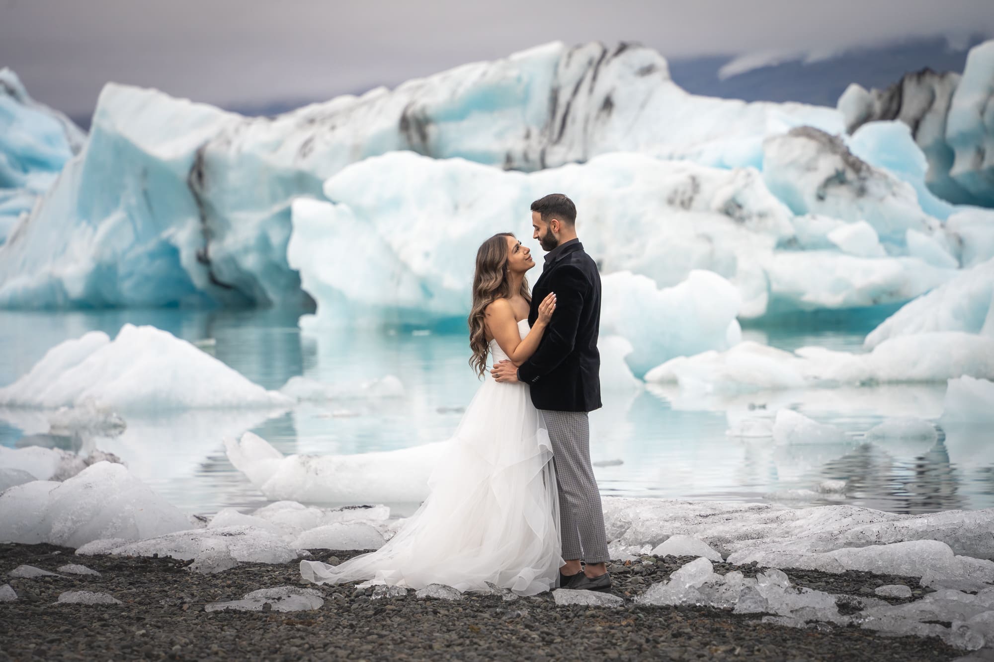 Couple eloping at Jökulsárlón glacier lagoon surrounded by icebergs in Iceland
