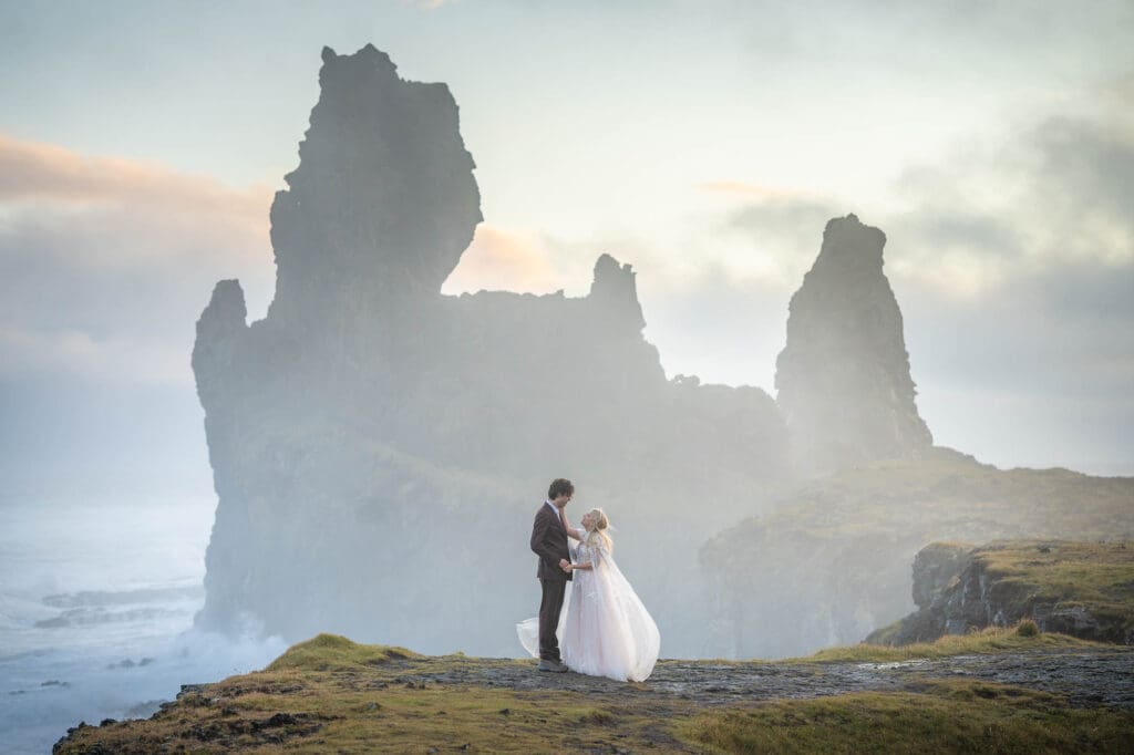Couple in wedding attire in Snaefellsnes Peninsula in Iceland at sunset